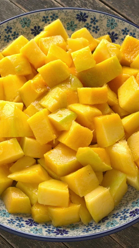 A rotating platter with ripe mango chunks. Vertical video. Stock Footage 325870030