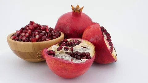 Rotating pomegranate fruit isolated on white background. Video stock 83667283