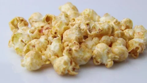 Rotating of popcorn with caramel. Side view, close up, macro. Stock Footage 135043092