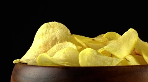 Rotating potato chips on black background Stock Footage 62958766