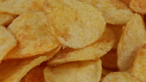 Rotating potato chips , macro view food background Stock Footage 77130055