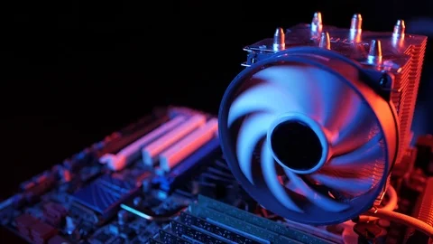 Rotating processor CPU fan installed on the motherboard on a black background Stock Footage 107004357