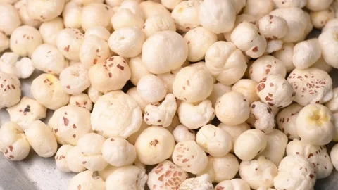Rotating Puffed Lotus Seeds Overhead Texture Healthy Makhana 4K Video Stock Footage 340753860