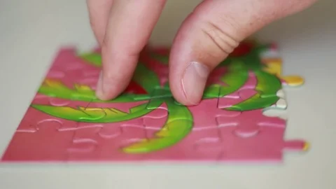 Rotating puzzle on white surface Stock Footage 77022170