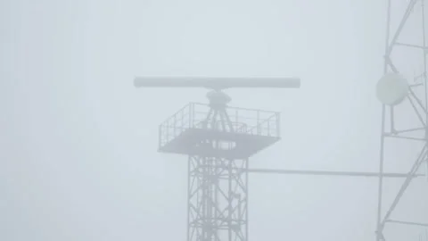 Rotating radar in a dense shroud of fog. Coastal surveillance system. Naval Stock Footage 304876868