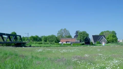 Rotating railway swing bridge over a river in the dutch countryside Stock Footage 336903044