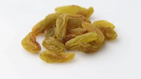 Rotating of raisins on white background. Side view. Stock Footage 136050646