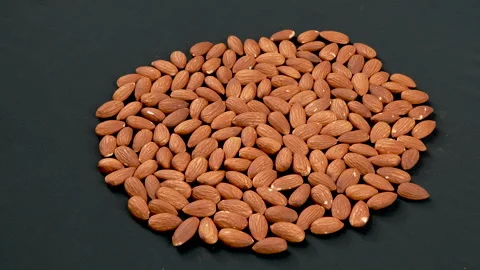 Rotating Raw Almonds on Black Background 4K Video stock 332845292