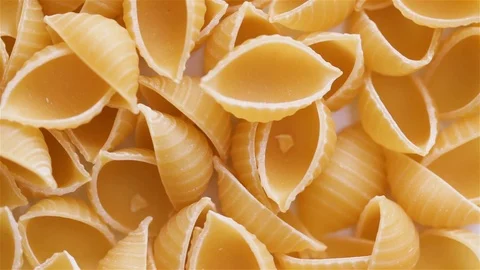Rotating Raw Pasta Shells Table Top 動画素材 102468381