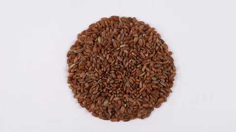 Rotating raw red rice on the turn table isolated on white background. View from  Stock Footage 87219943