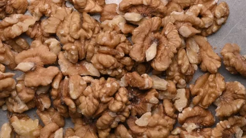 Rotating Raw Walnut Kernels Top View Healthy Nut Texture Macro 4K Video Stock Footage 340748642