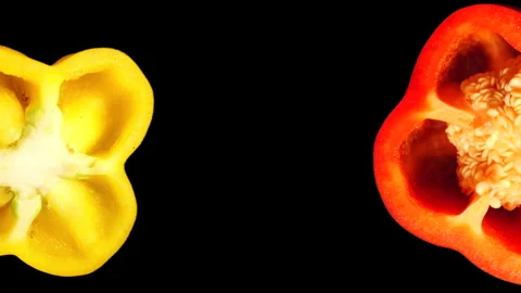 Rotating Red and Yellow Pepper Slices on Black Background in 60p Stock Footage 337682689