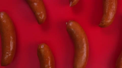 Rotating red background with barbecue sausages Stock Footage 197376623