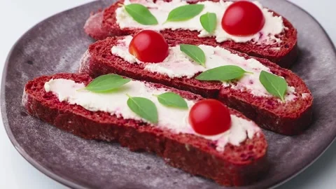 Rotating of red beet bread sandwiches with cream cheese and tomatoes. Stock Footage 137661074