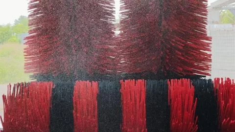 Rotating red black brushes of automatic car wash closeup no vehicle Stock Footage 336090885