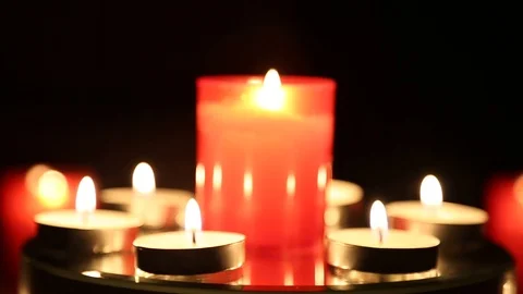 Rotating Red Candles Burning And Shimmering In The Dark Stock Footage 85635124
