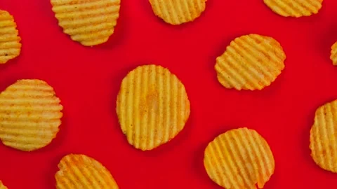 Rotating red with corrugated Ruffled potato chips Stock Footage 196243630