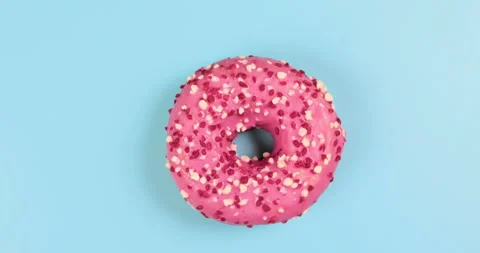 Rotating red donut on blue background 스톡 동영상 234969122