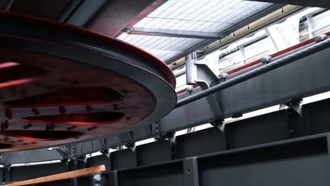 Rotating red flywheel on ropeway mashine room Stock Footage