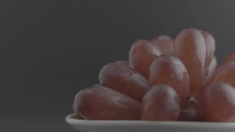 Rotating Red Grapes with Water Drops in White Bowl Stock Footage 344799280