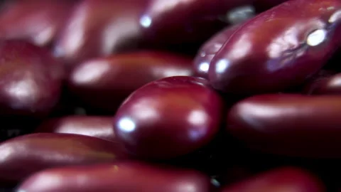 Rotating red kidney beans heap macro shot on dark background Stock Footage 338126938
