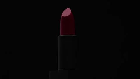 Rotating red lipstick on a black background as a presentation of cosmetics Stock Footage 263976203