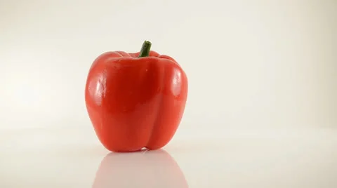Rotating Red Pepper On Acrylic Against White - Dolly Right Stock Footage 23845732