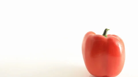 Rotating Red Pepper On Acrylic Against White - Crane Down Video stock 23845772