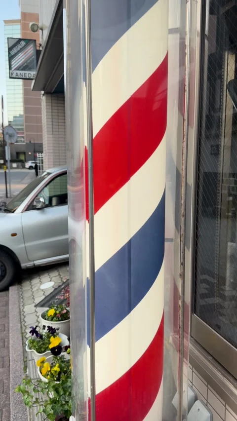 Rotating Red White and Blue Barber Pole Outside Japanese Hair Salon Stock Footage 344942605