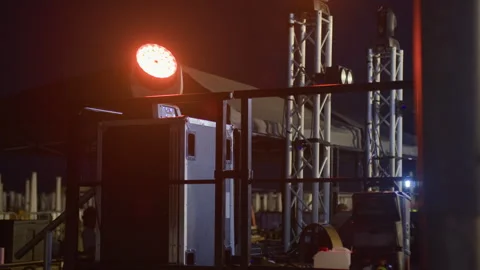 Rotating RGB circular stage light with wide view of concert stage Stock Footage 313789243