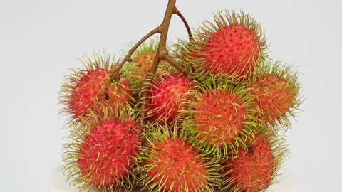 Rotating Ripe Red Rambutan Fruit Bunch on White Background 動画素材 336318500