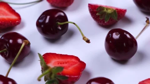 Rotating ripe strawberries and cherries on a white background.Trendy,fruity Stock Footage 217360996