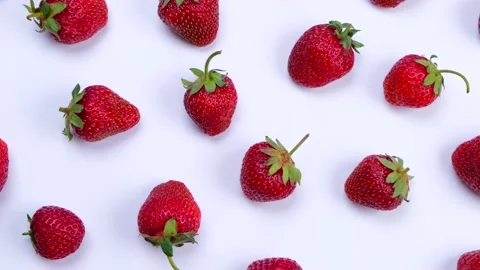 Rotating ripe strawberries on a white background, trendy, bright, summer Stock Footage 198131391