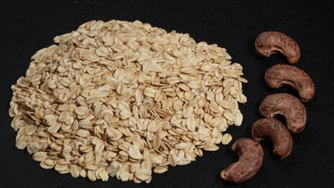 Rotating Rolled Oats and Salt Roasted Cashews with Skin. Video stock 333090351
