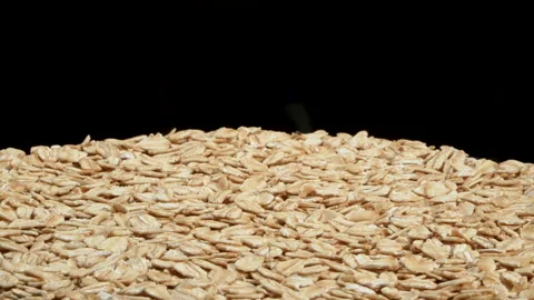 Rotating Rolled Oats Lower Half Frame on Black Background. 스톡 동영상 333048352