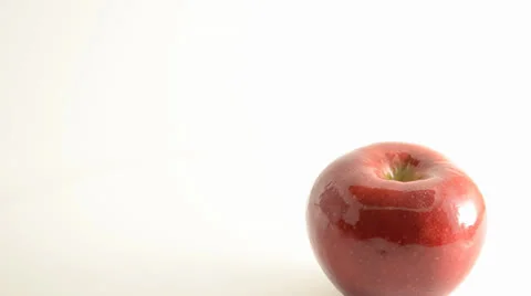 Rotating Rome Apple On Acrylic Against White - Crane Down Stock Footage 24470166