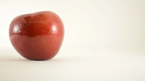 Rotating Rome Apple Against White - Dolly Right Stock Footage 24470995