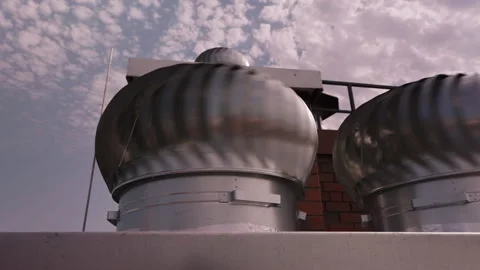 Rotating rooftop turbine ventilators against cloudy sky Stock-Footage 343450132