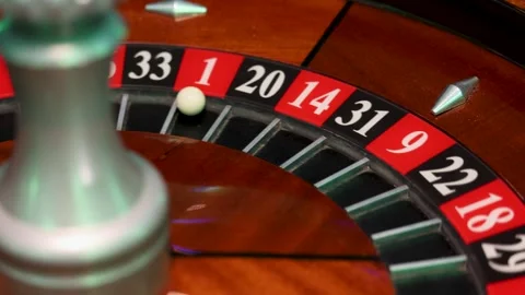 Rotating roulette wheel with central spindle and ball in pocket 1 Stock Footage 336406378