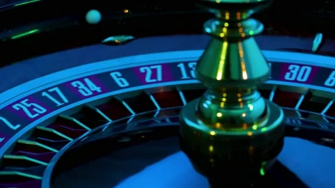 Rotating roulette wheel close up in the rays of blinking neon lights. The small Stock Footage 154352511