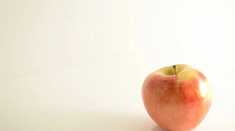 Rotating Royal Gala Apple On Acrylic Against White - Crane Down Stock Footage 24469966