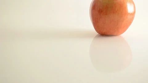 Rotating Royal Gala Apple On Acrylic Against White - Crane Up Stock Footage 24469980