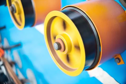 Rotating rubberized wheels of the winding machine Stock Photos