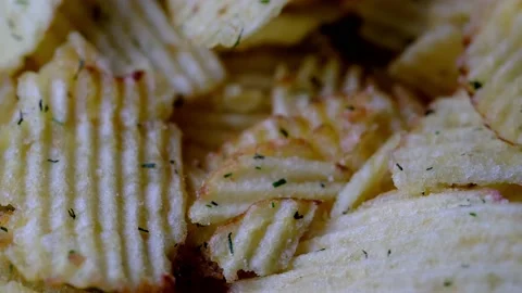 Rotating ruffled potato chips with dill Stock Footage 218317869