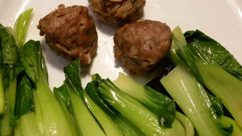 Rotating of sauteed vegetable and meatball inside Chinese restaurant Stock Footage 100098443