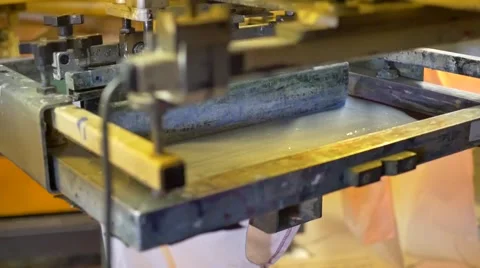 Rotating screen printer rolling paint onto shirts Video stock 54678904