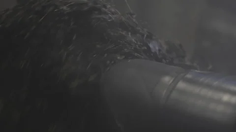 Rotating shaft pushes shredded rubber into deep container Vídeo Stock 314640323