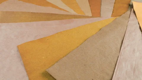 Rotating sheets of handmade paper in earthy ochre and natural beige tones. Stock Footage 330246728