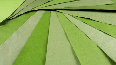 Rotating sheets of handmade paper in various shades of moss, olive. Stock Footage 330248767