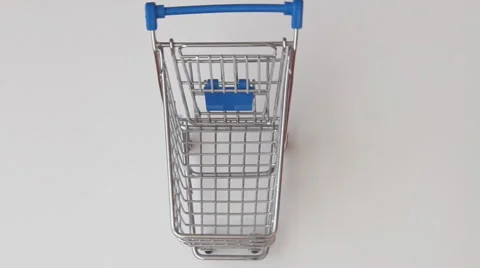 Rotating shopping cart with falling sweets Stock Footage 44341984